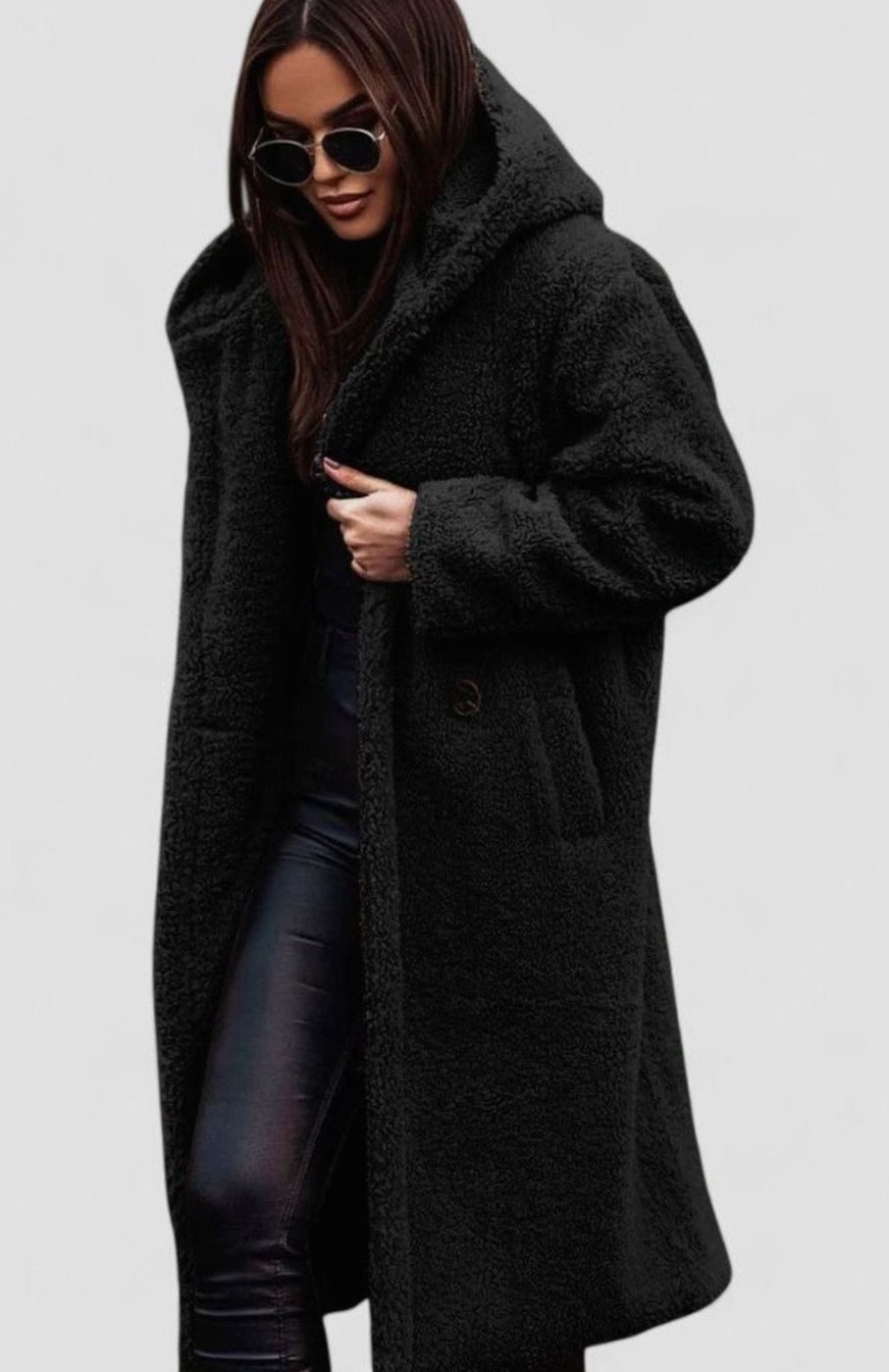 Mujer luciendo abrigo teddy largo combinado con look urbano
